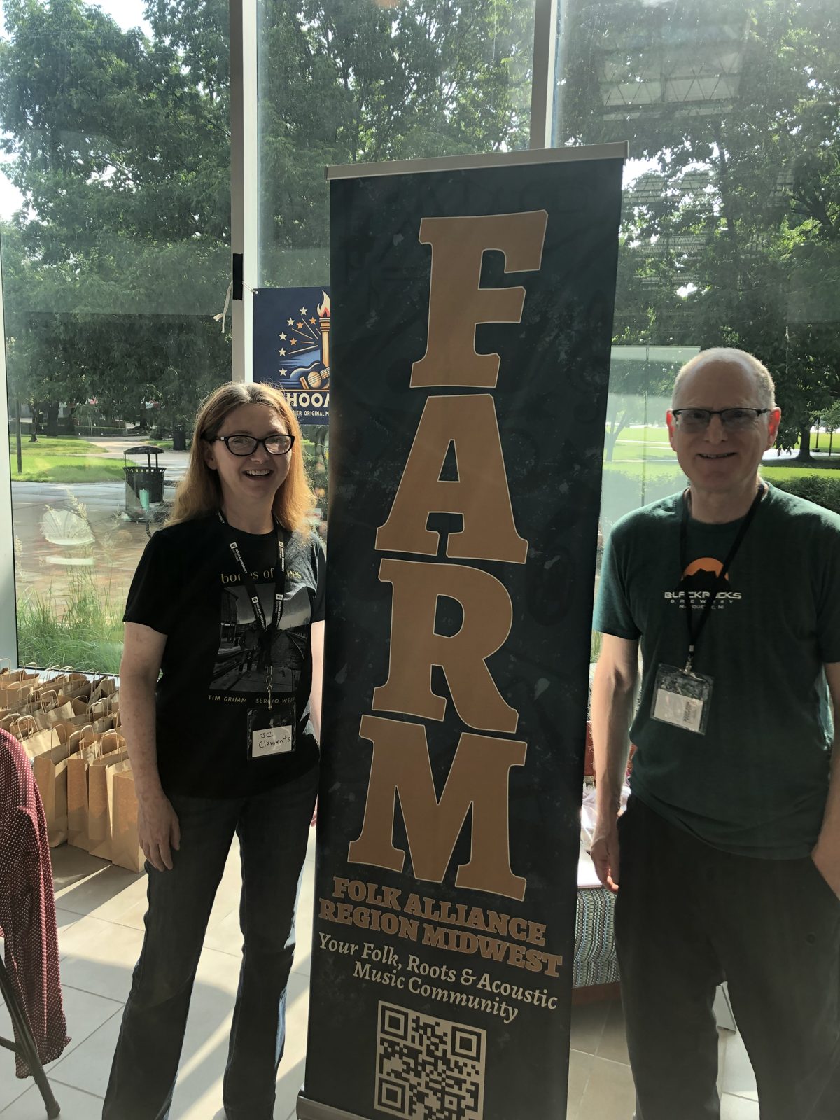J C Clements and Mike Green beside the FARM banner