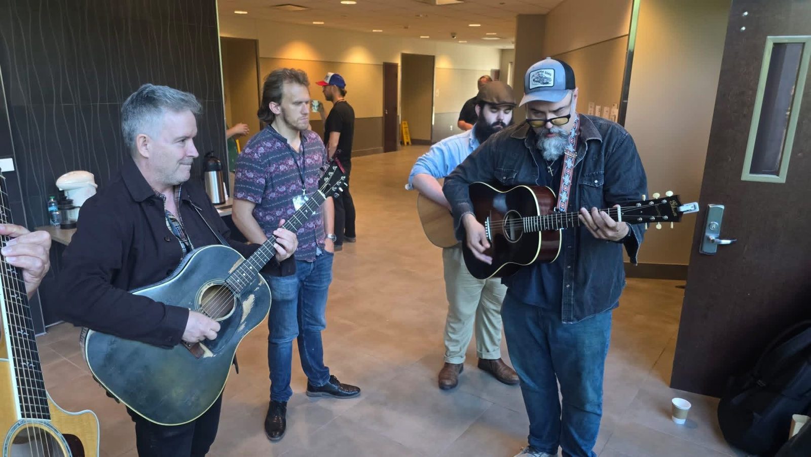 Tim Easton and attendees playing guitars together in a hallway at IU South Bend
