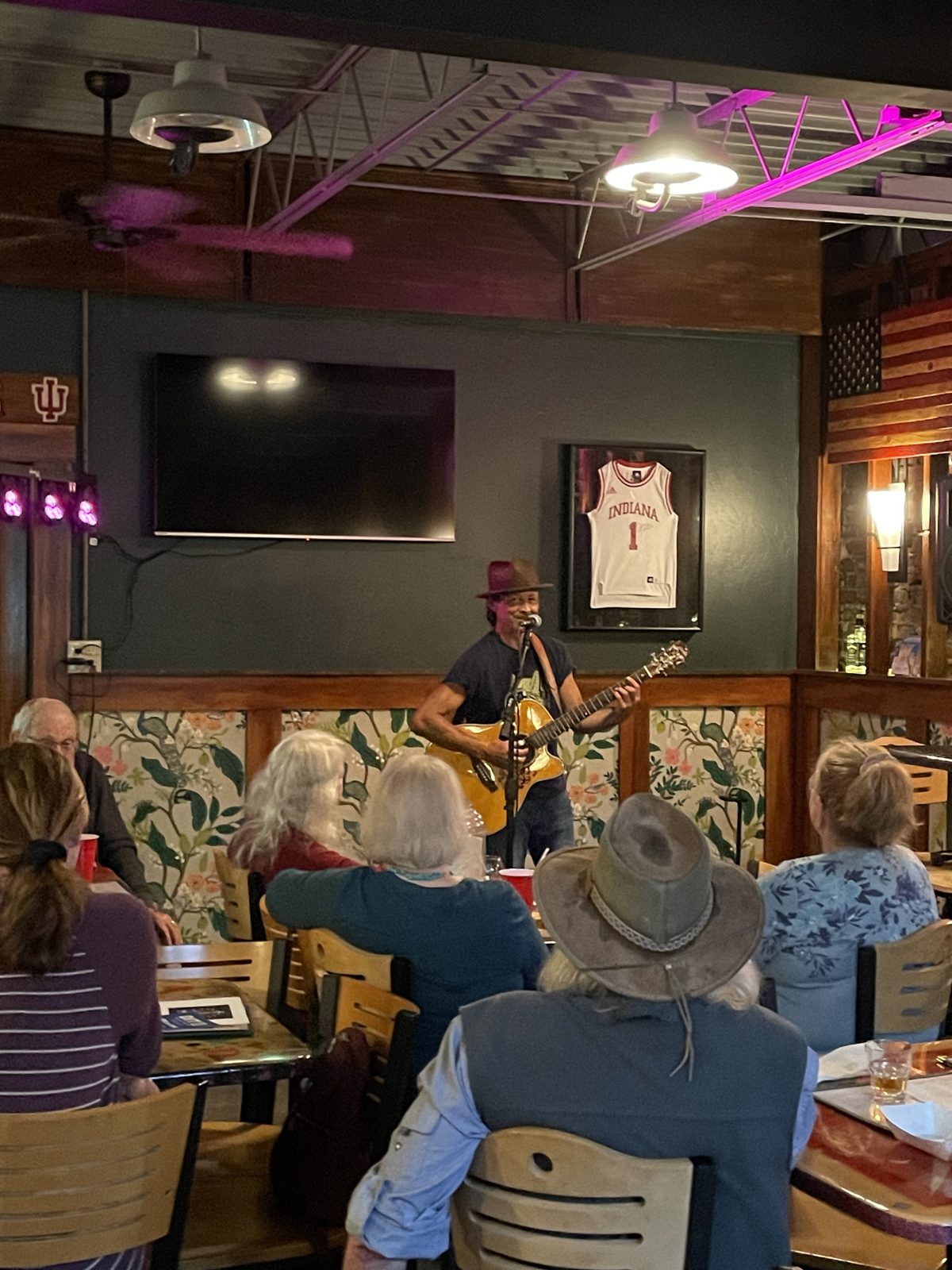 A songwriter in a hat performing at Sleeper's